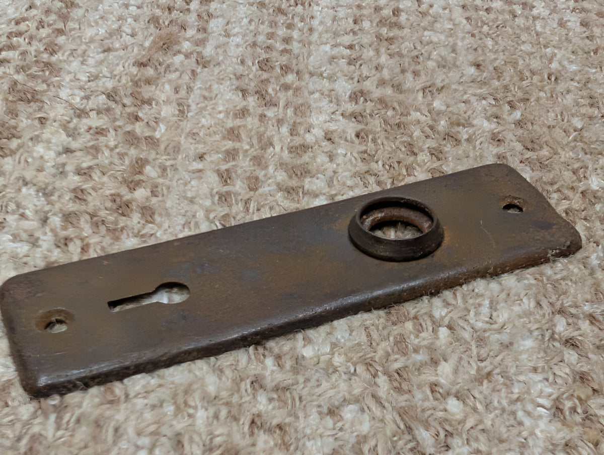 1 5/8" x 5 3/8" Antique Stamped Steel Door Knob Plate