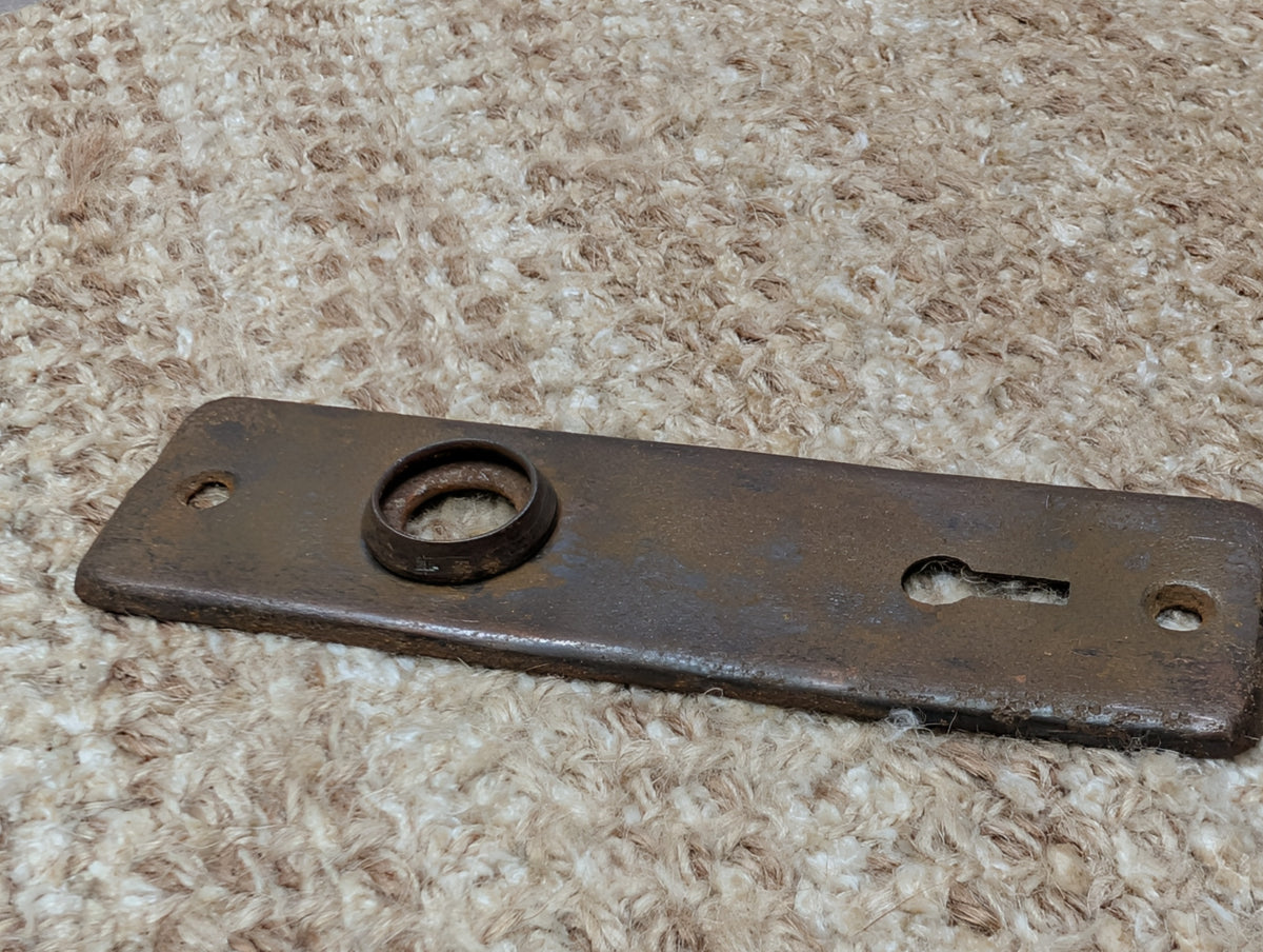 1 5/8" x 5 3/8" Antique Stamped Steel Door Knob Plate